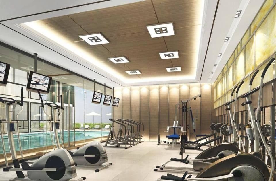 Gym with cardio machines and a view of the pool